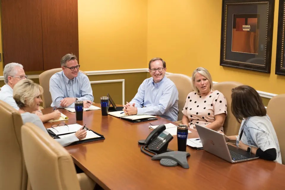 Stapleton team members meeting around a conference table