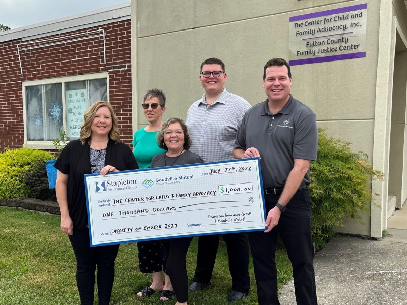 Stapleton team members presenting a $1,000 Charity of Choice check to The Center for Child and Family Advocacy in Fulton County
